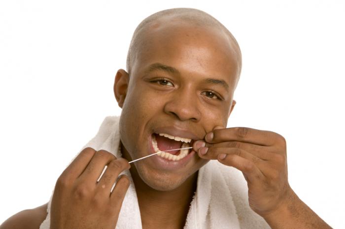 Man flossing teeth